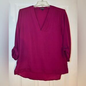 Express magenta colored roll sleeve v neck blouse.